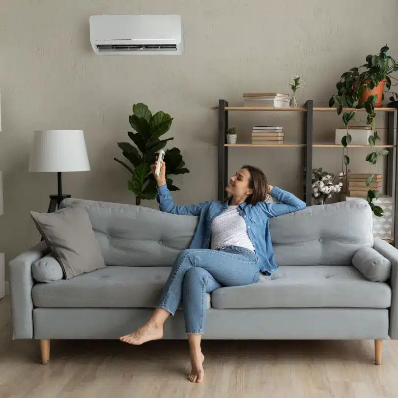 Our customer enjoying her newly installed airconditioning system while resting on her couch in the living room.